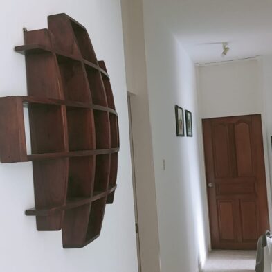 Decorative wooden wall shelf mounted with concealed brackets for sturdy support by fixinguru singapore